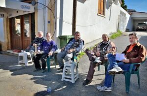 men sitting on the chairs on the street in lefka northern cyprus ekhwx e